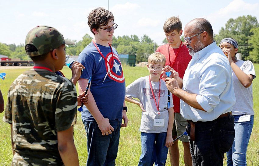 East Mississippi Community College Board of Trustees member Greg Stewart, at right, who also works for Aurora Flight Sciences, shows students enrolled in EMCC’s Camp AMP how to prepare rockets for launch. East Mississippi Community College Board of Trustees member Greg Stewart, at right, who also works for Aurora Flight Sciences, shows students enrolled in EMCC’s Camp AMP how to prepare rockets for launch.